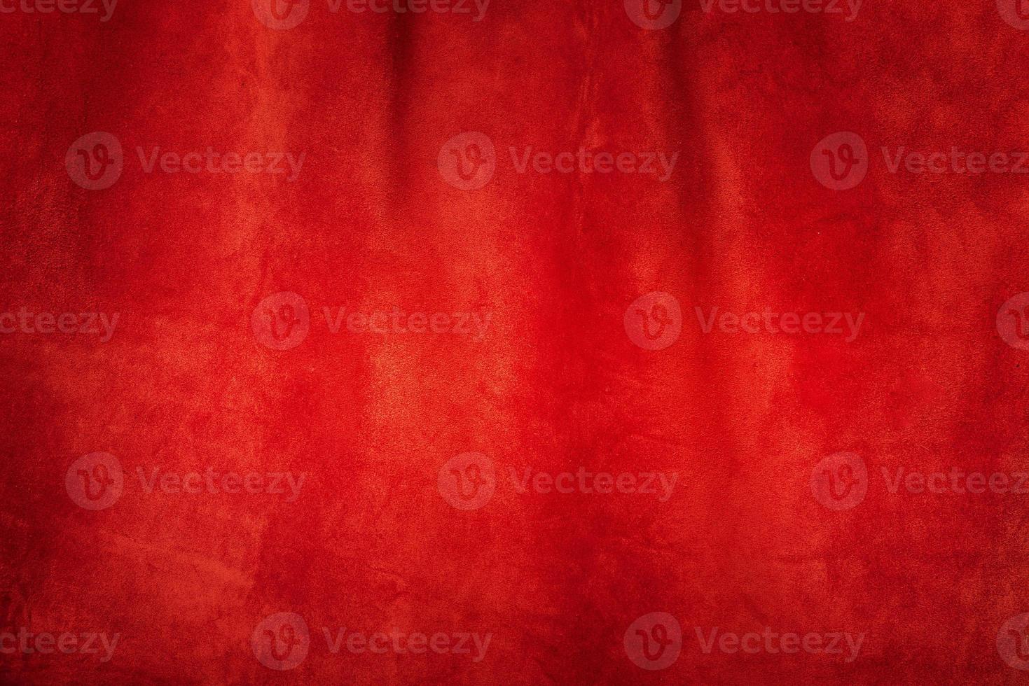 Red matte background of suede. Velvet texture of seamless leather. Red suede texture. photo