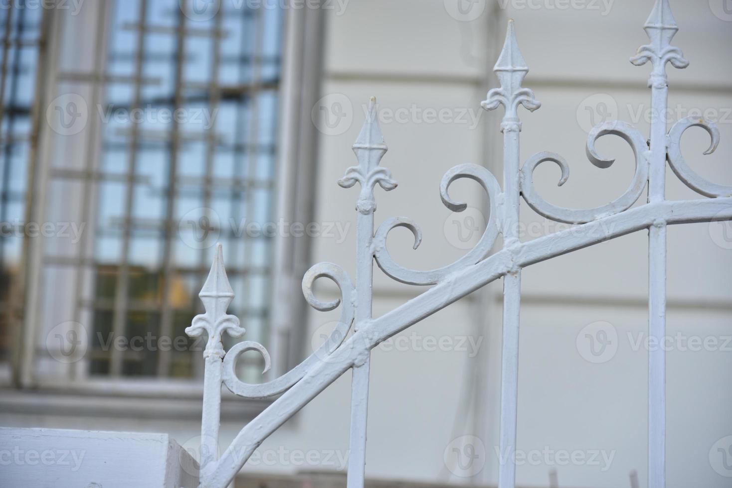 Iron fence with pins and lanterns in the city photo