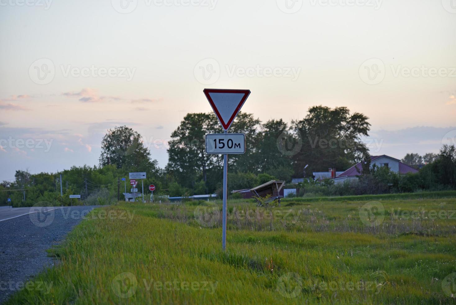 Asphalt road in the forest in the evening photo