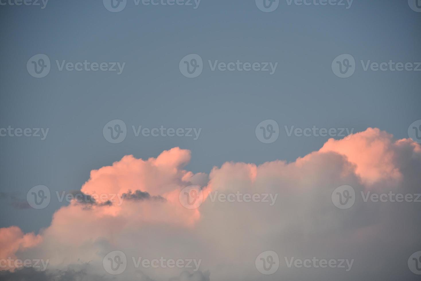 Evening storm clouds illuminated by the evening sun photo