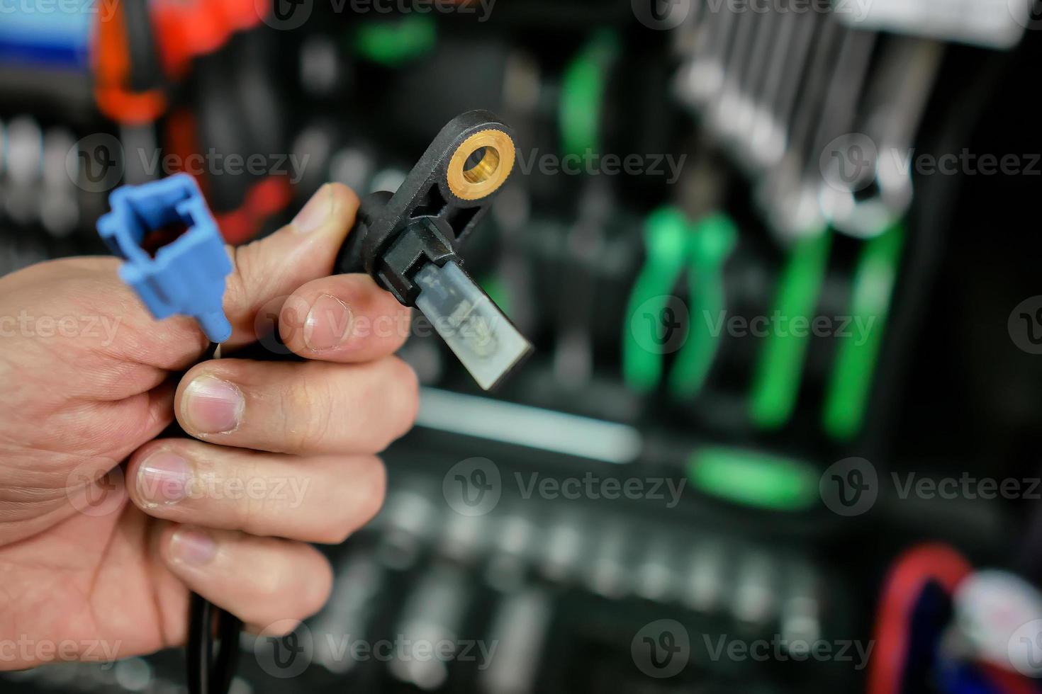 ABS sensor in the hands of an auto mechanic photo