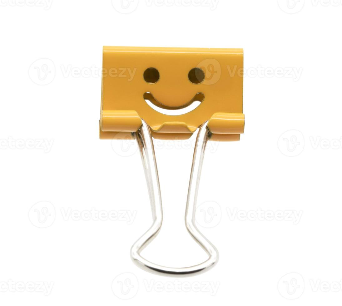 Smile orange binder clip isolated on white background photo