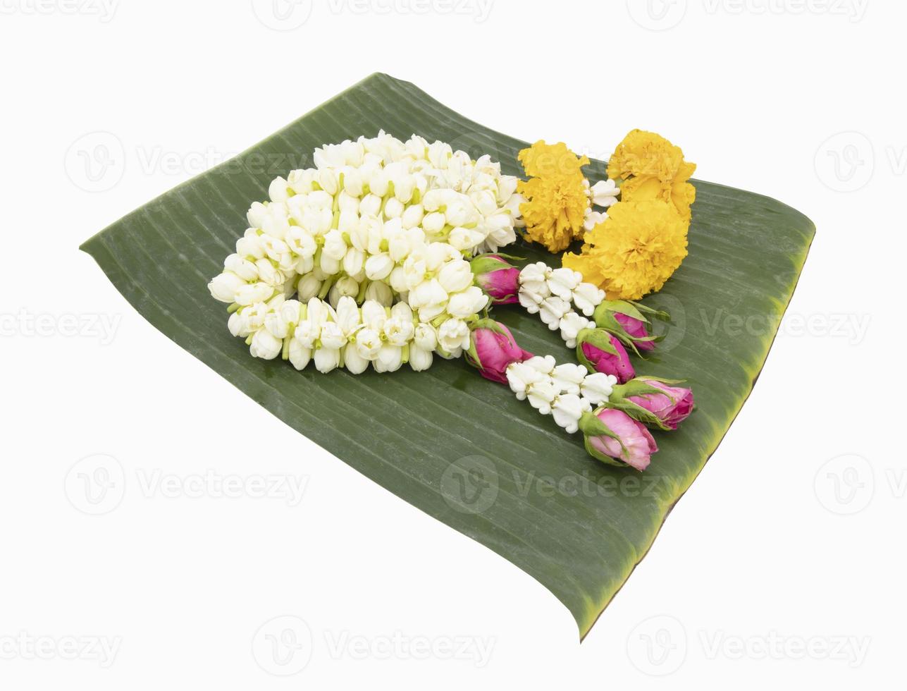 White jasmine garland on green banana leaf background photo