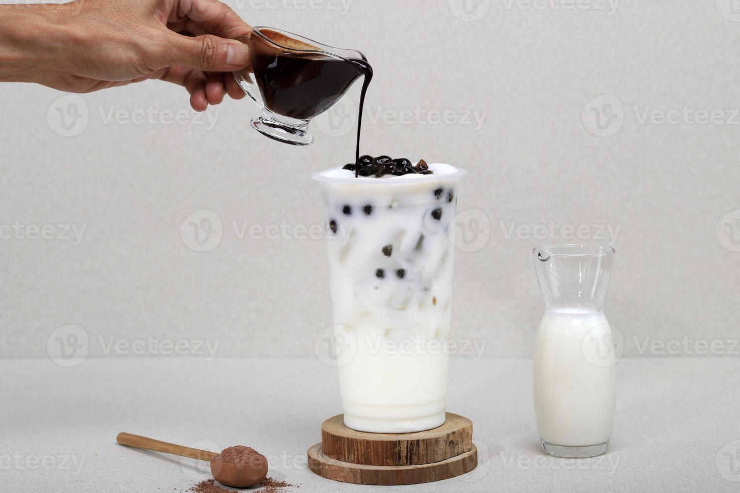Boba milk tea with brown sugar syrup in a tall glass photo