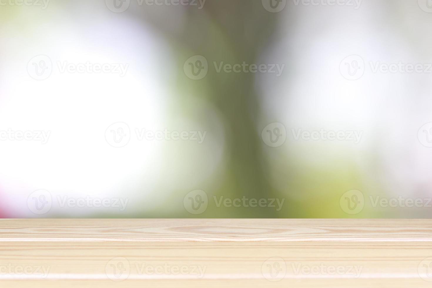 Empty wooden table with blurred light bokeh on background space background montage style, For place the product. photo