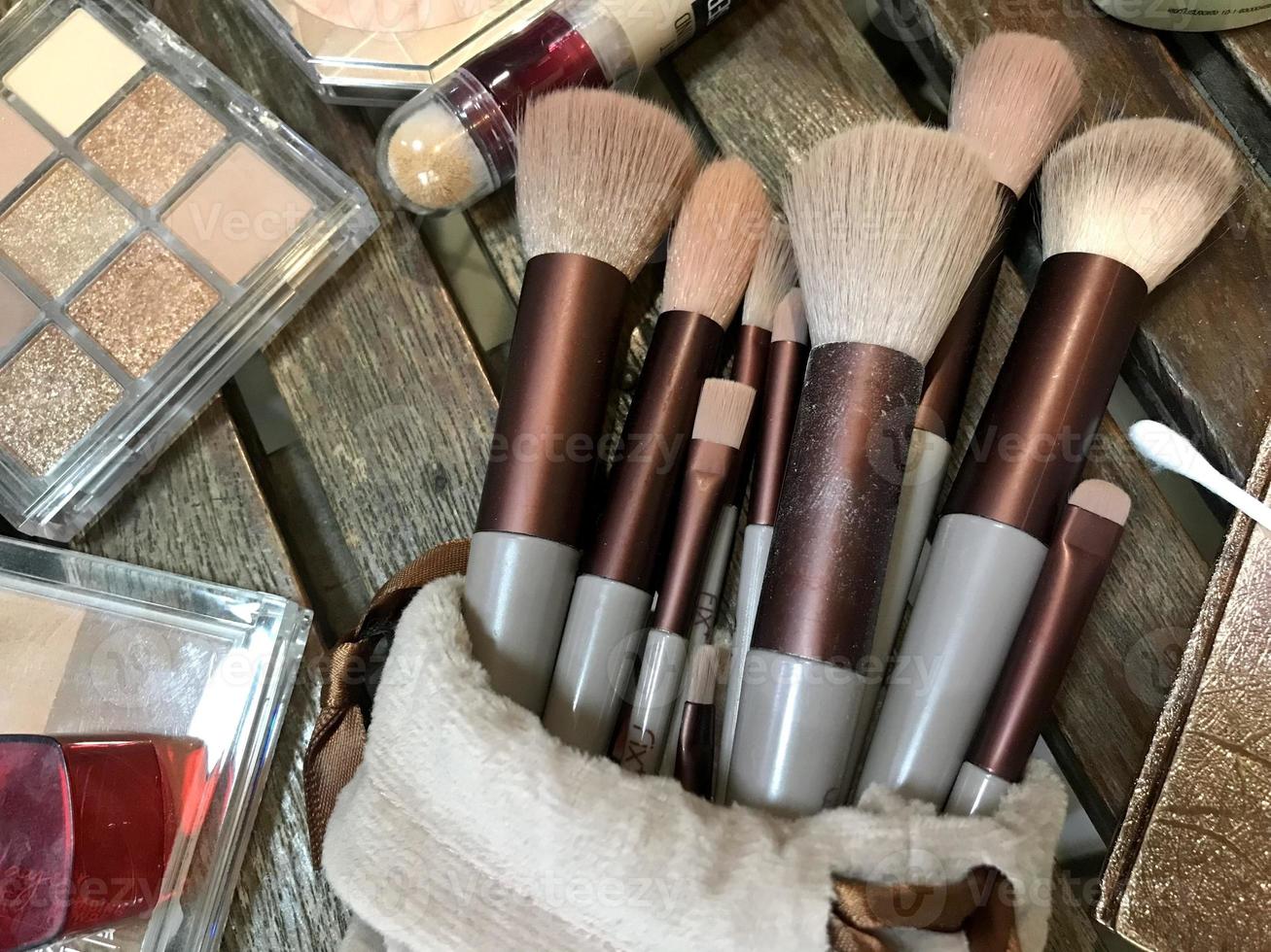 Makeup artist tool set brown and gold tone color for eyes and eyebrows, powdering, highlighter, smudging, blurring. For professional cosmetic service. photo