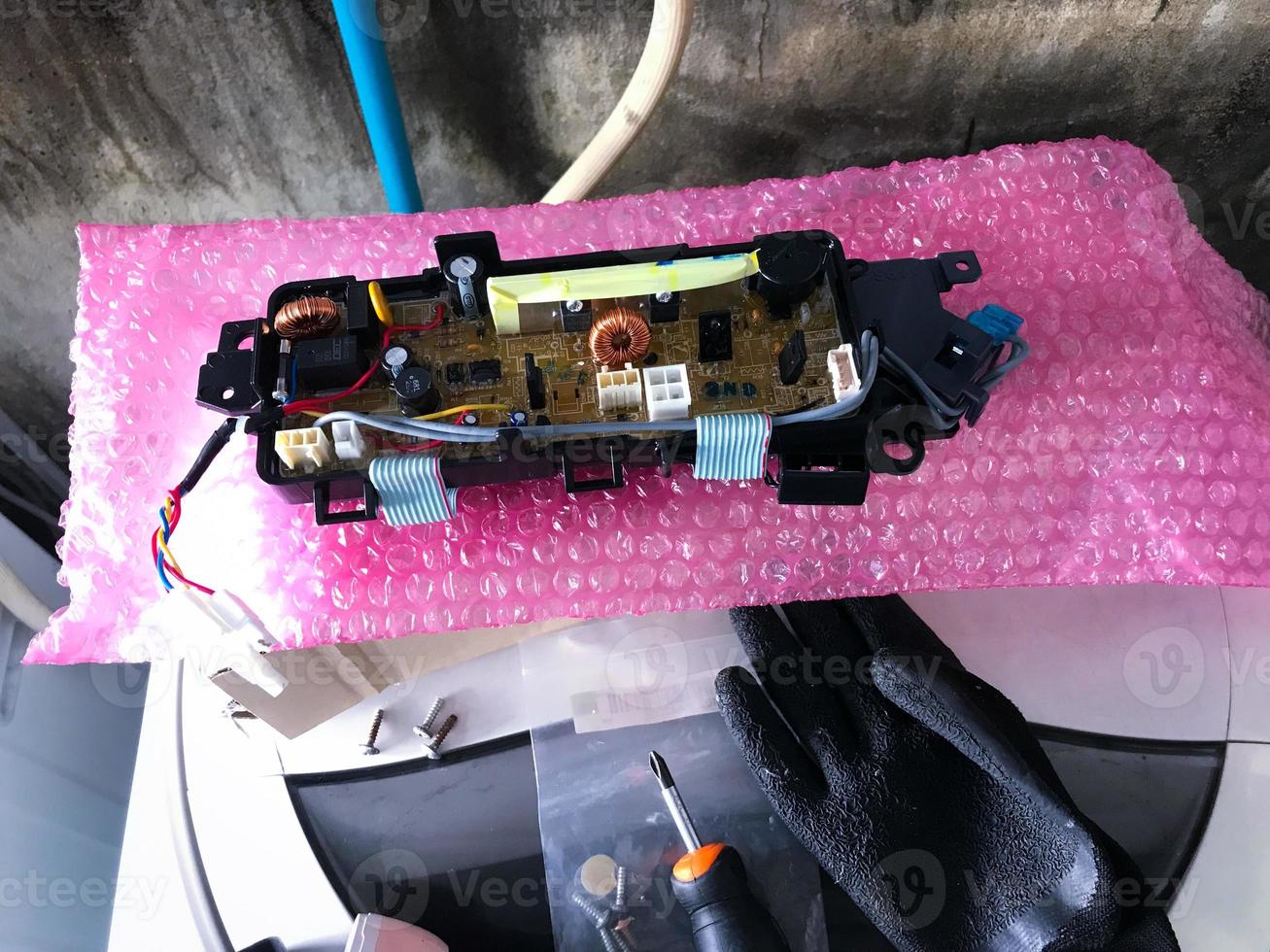 Control panel for top-loading washing machines, Service technician replacing new parts photo