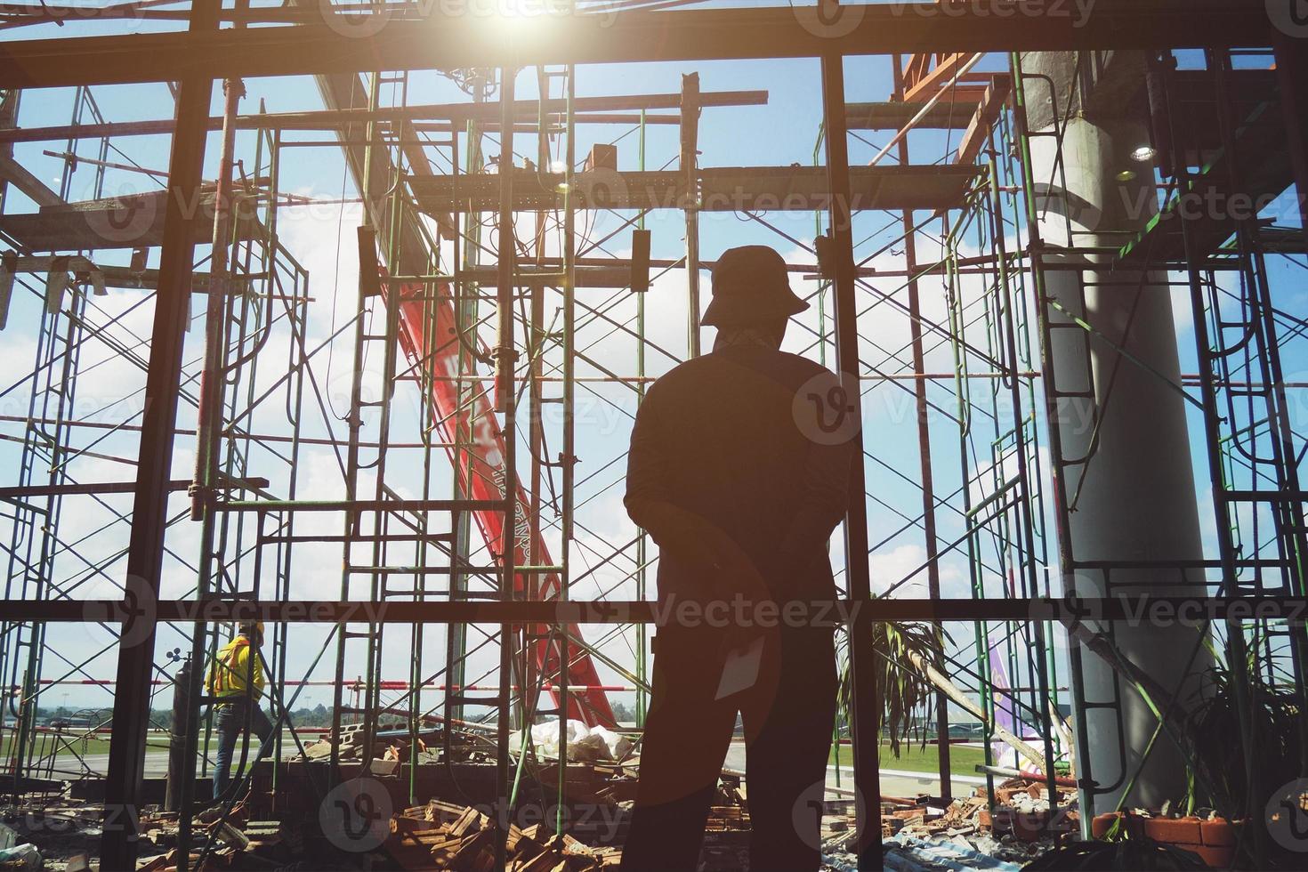 Worker man standing at the construction site photo