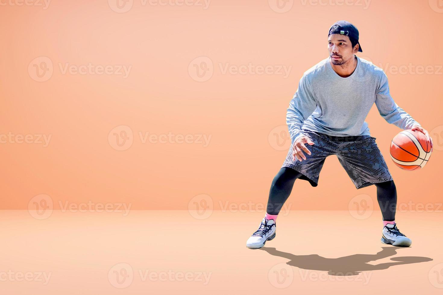 Asian basketball player on colored background photo