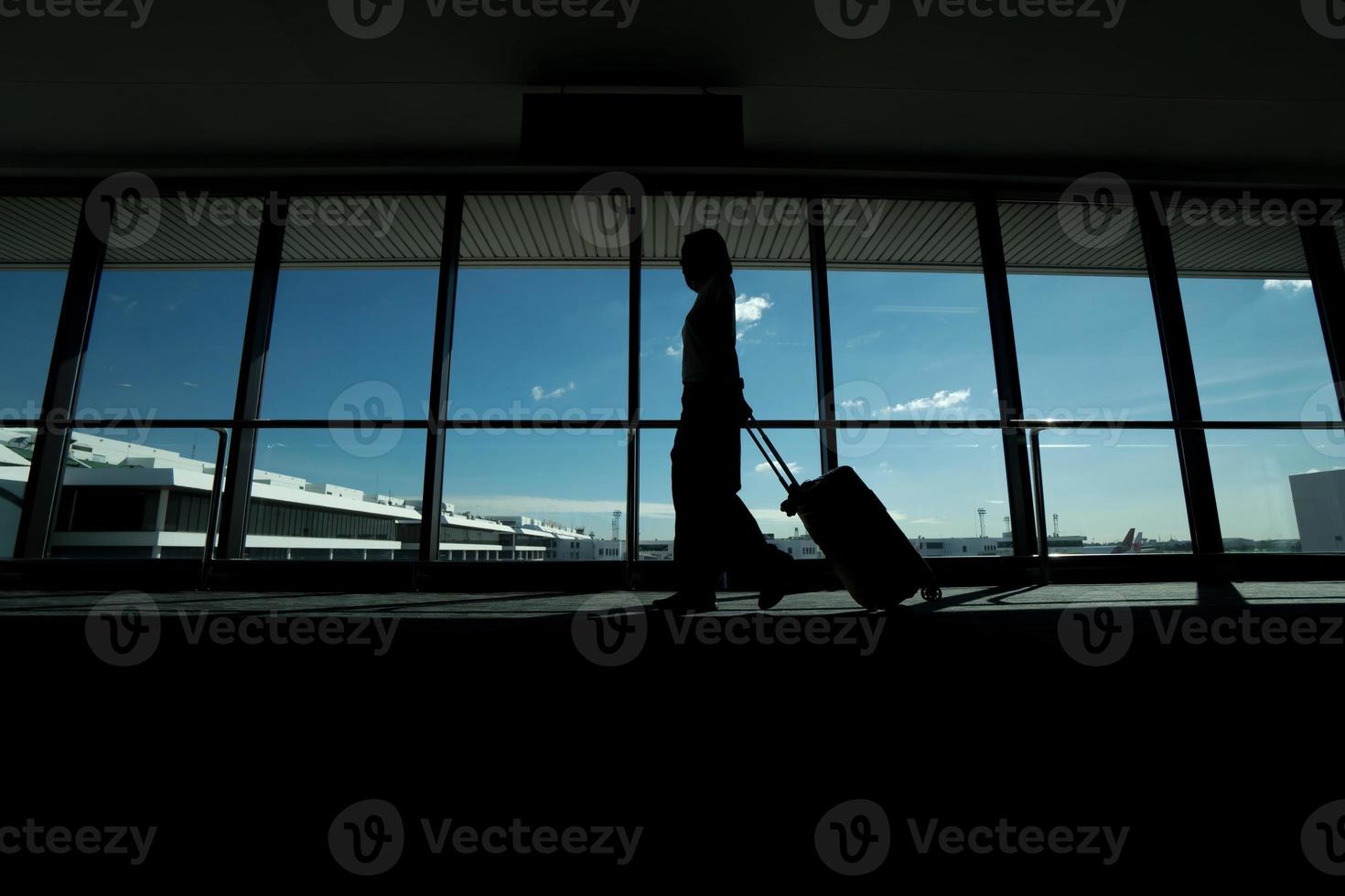 Traveler women and luggage at airport terminal Travel concept photo