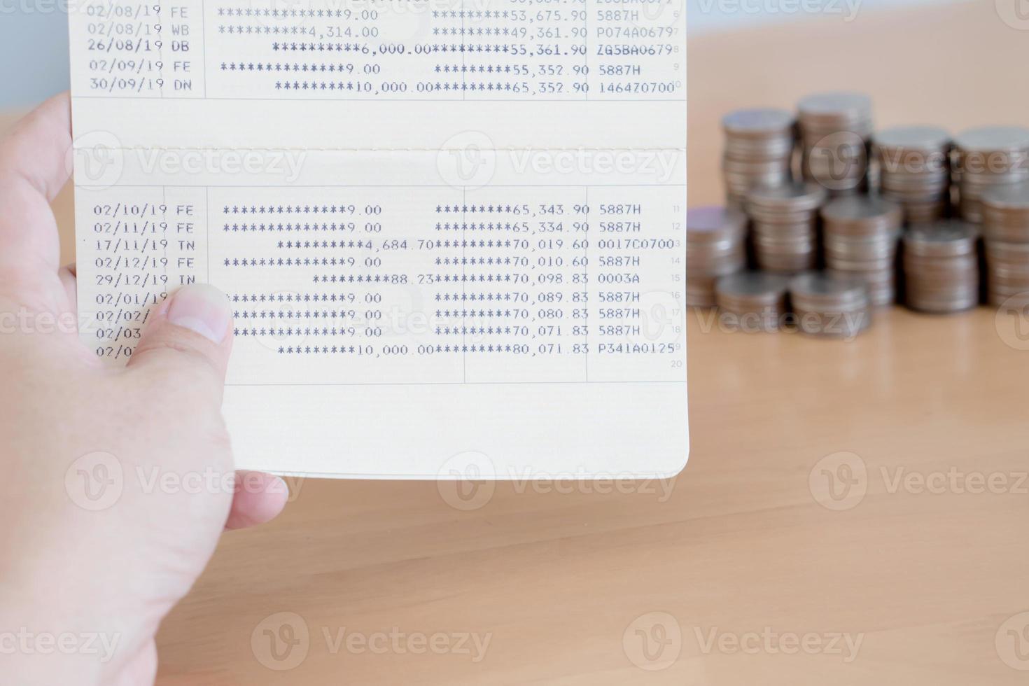 Woman hold passbook on hand, coins background photo