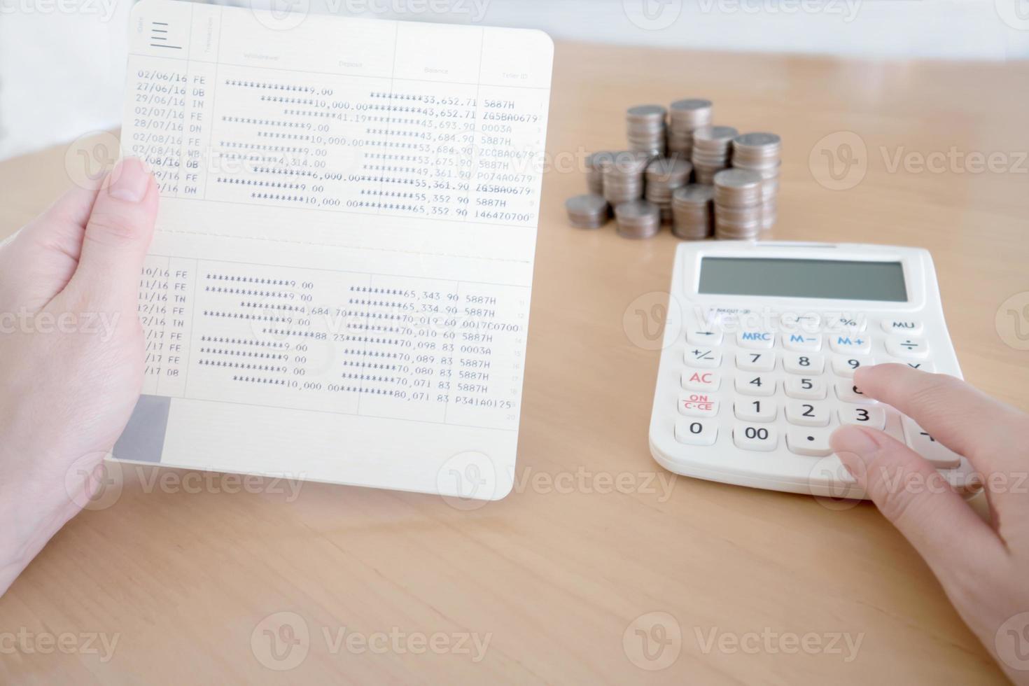 Women checking amount in bank account passbook photo