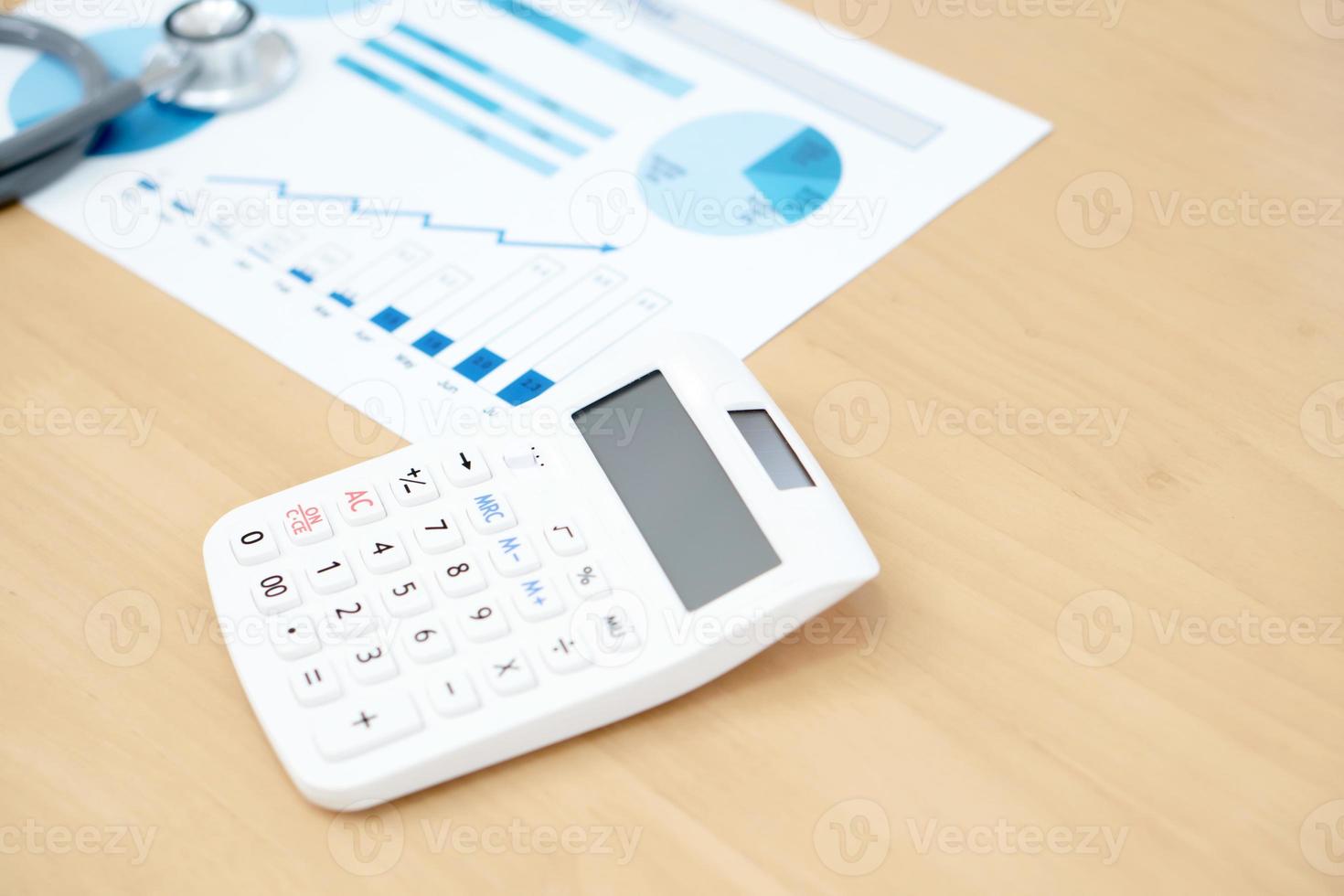 Financial statement with stethoscope and calculator photo