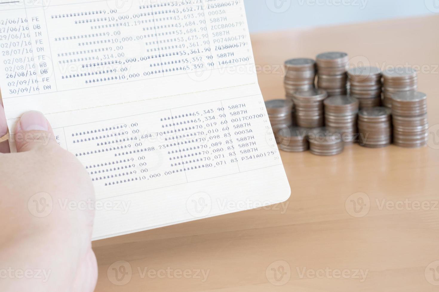 Woman hold passbook on hand, coins background photo