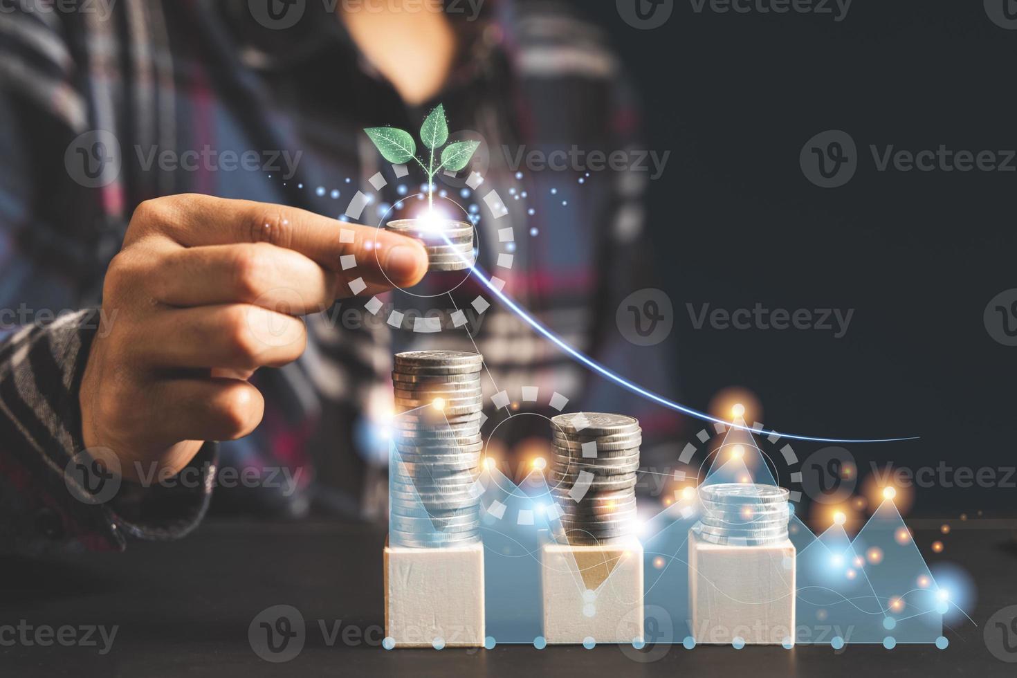 Hand puting coin on stacking coins.money saving concept photo