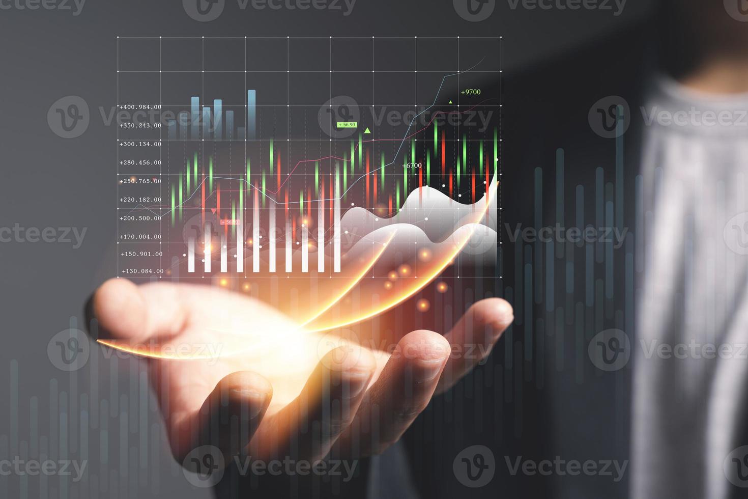 Businessman or trader is showing a growing virtual hologram stock, invest photo