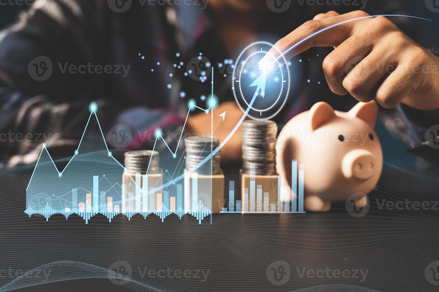 Hand puting coin on piggy bank and stacking coins.money saving concept photo