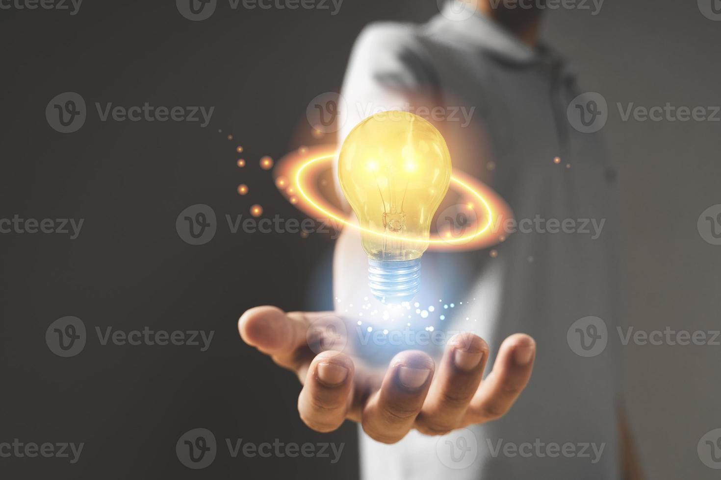 hand with light bulb. idea concept with innovation and inspiration photo