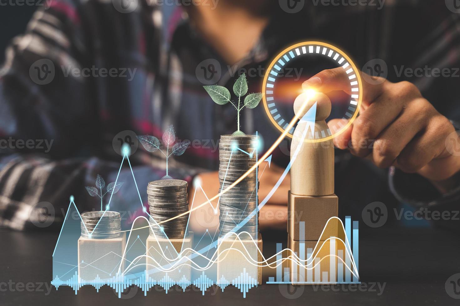 Businessman is touching a growing virtual hologram stock and rows of coins, Business stock analysis. photo