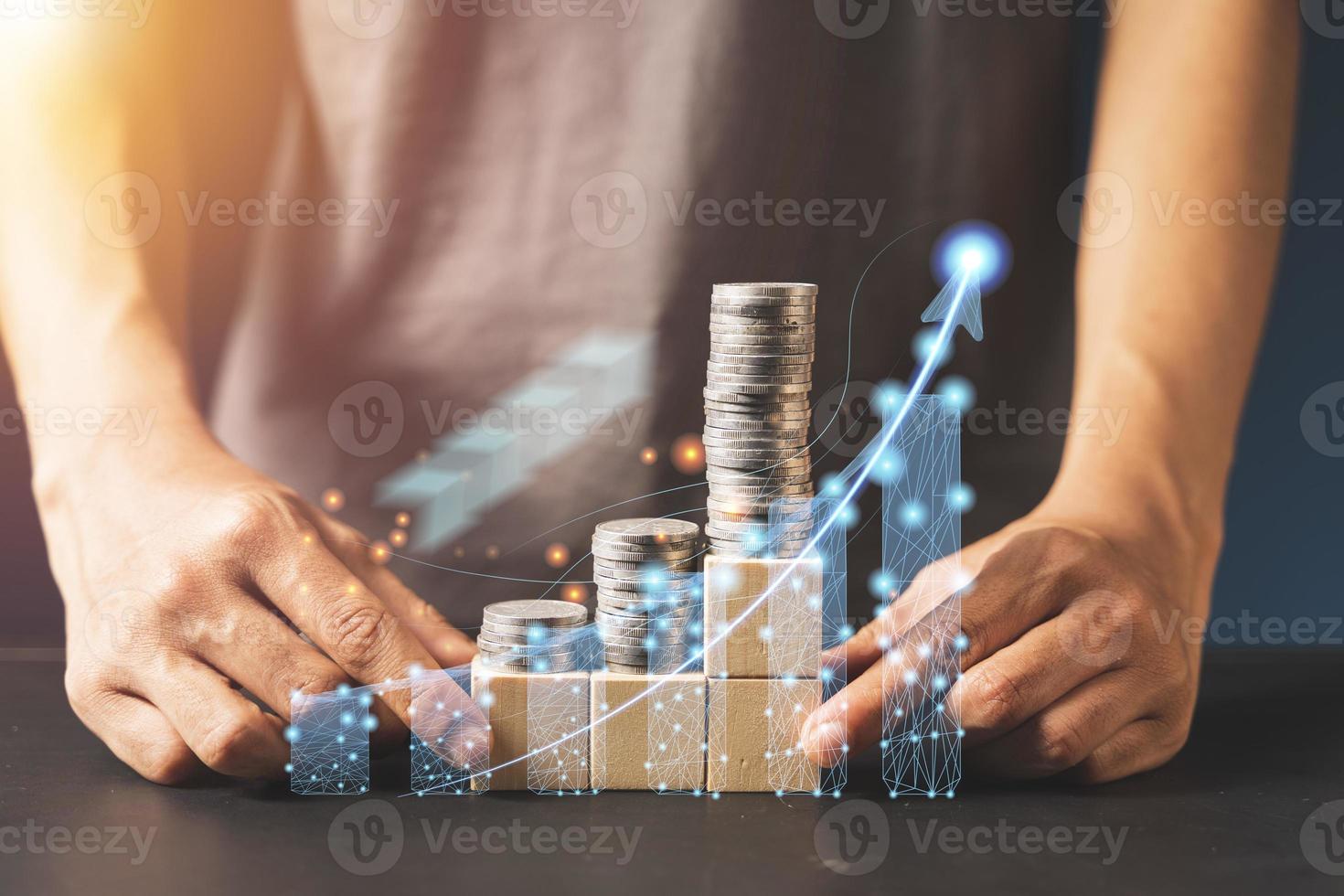 Businessman is touching a growing virtual hologram stock and rows of coins, Business stock analysis. photo