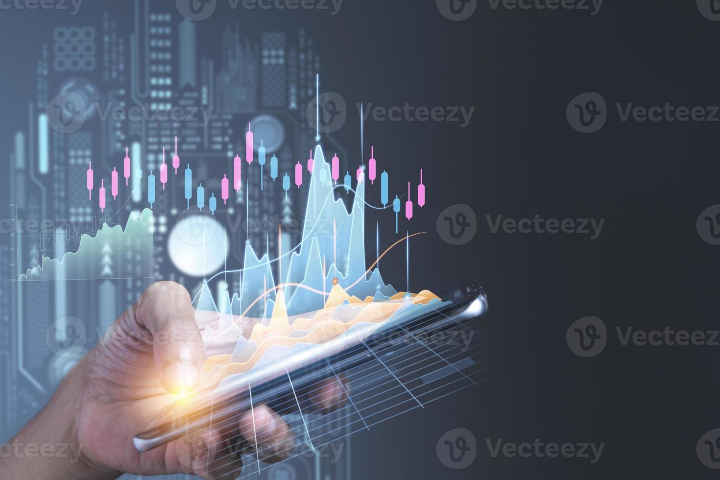 Man using mobile phone checking stock market graph report via mobile apps photo