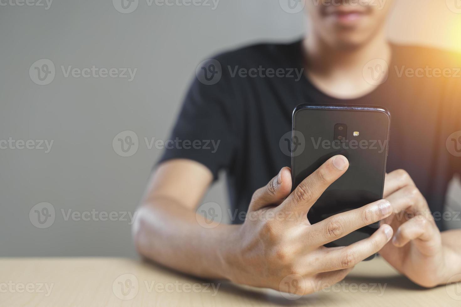 Close-up of male hands using smartphone photo