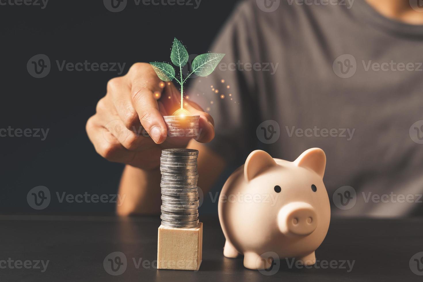 Hand puting coin on stacking coins piggy bank and .money saving concept photo