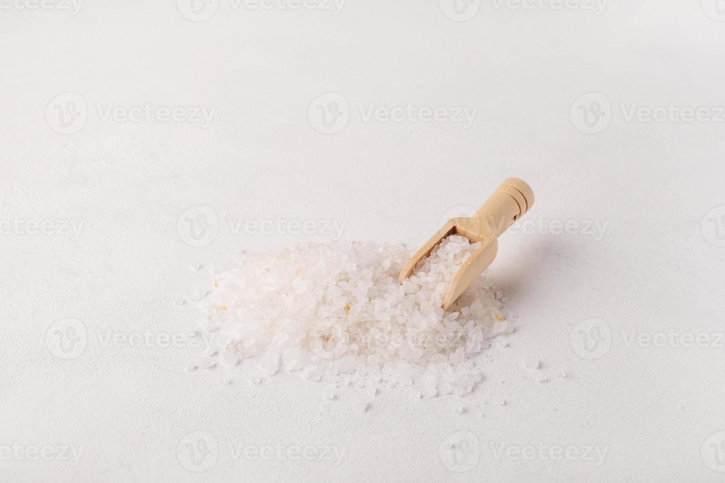 Organic spa sea salt and wooden scoop photo