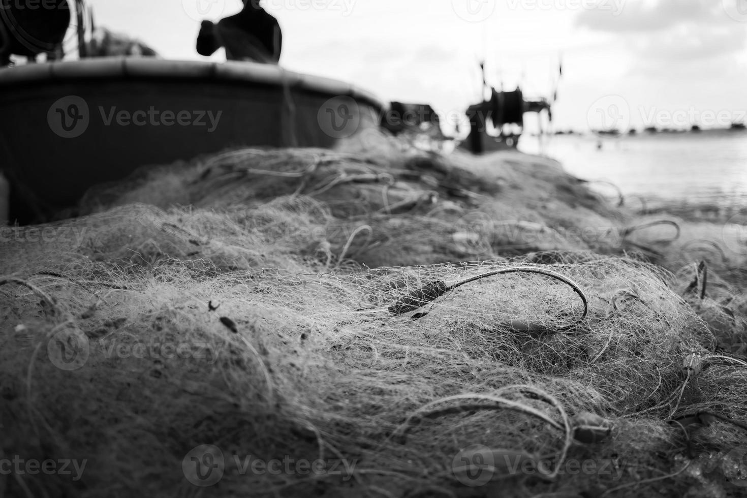 Sea nets - fishing equipment or tackle as texture backdrop with natural sunlight and shadow. Black and white textured background of fishing nets close-up, marine design for craft of fishermen. photo