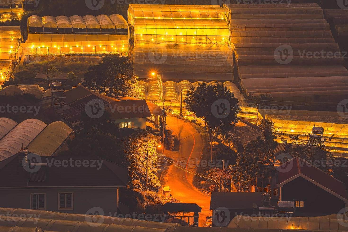 Amazing sunset landscape in agricultural greenhouse valley in Da Lat City. The light from the greenhouse to grow flowers in Da Lat. Travel and landscape concept photo