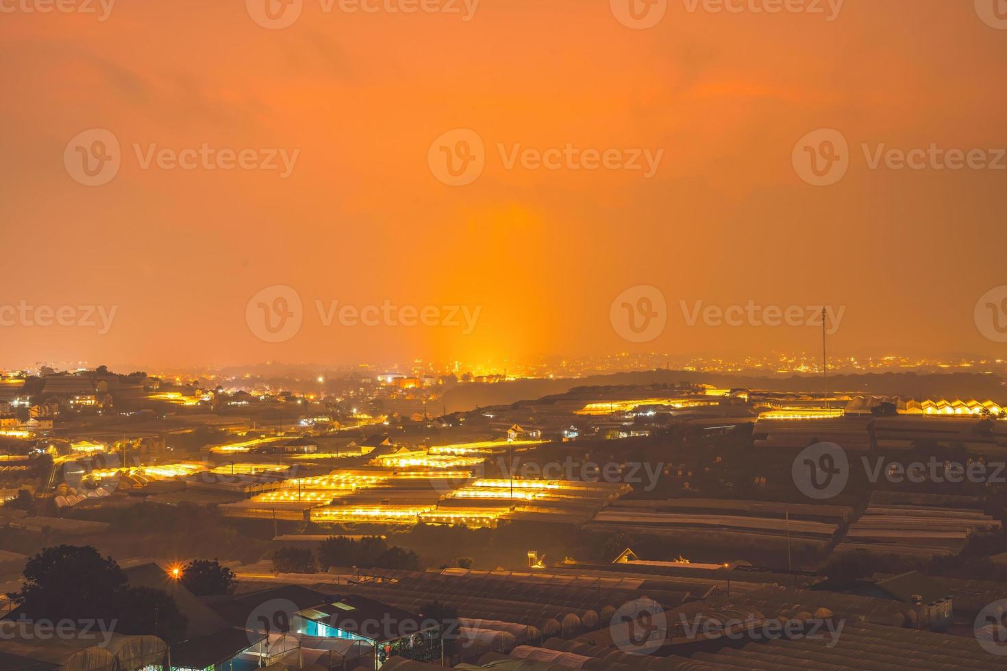 Amazing sunset landscape in agricultural greenhouse valley in Da Lat City. The light from the greenhouse to grow flowers in Da Lat. Travel and landscape concept photo