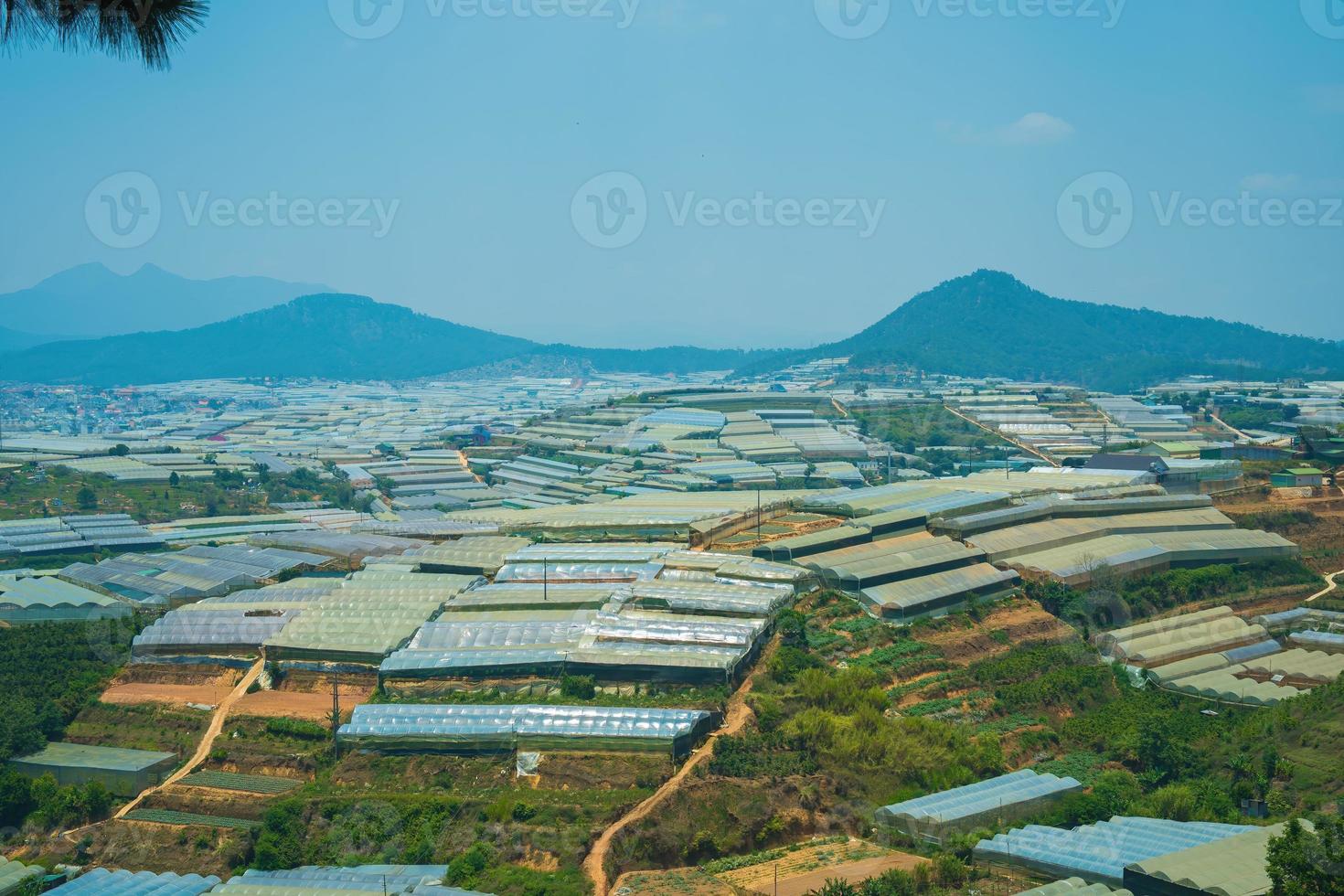 Amazing sunrise landscape in agricultural greenhouse valley in Da Lat City. The light from the greenhouse to grow flowers in Da Lat. Travel and landscape concept photo