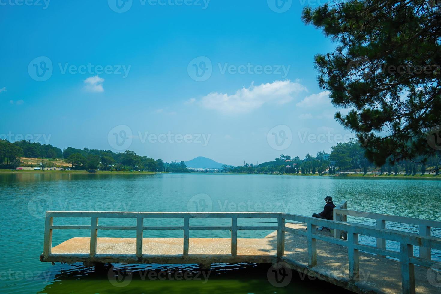 Fabulous sunrise by Xuan Huong Lake, in center Da Lat City, Lam Dong Province, Vietnam. This artificial lake in the city centre is a favourite place for tourists and locals for walking. photo