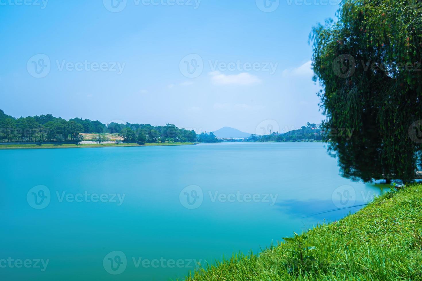 Fabulous sunrise by Xuan Huong Lake, in center Da Lat City, Lam Dong Province, Vietnam. This artificial lake in the city centre is a favourite place for tourists and locals for walking. photo