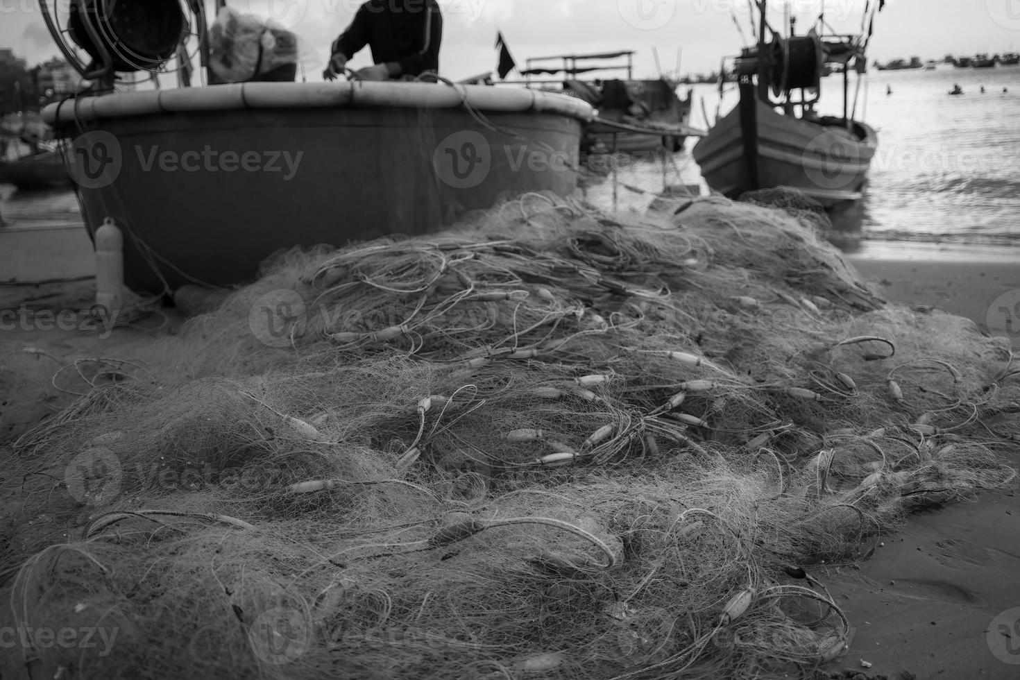 Sea nets - fishing equipment or tackle as texture backdrop with natural sunlight and shadow. Black and white textured background of fishing nets close-up, marine design for craft of fishermen. photo