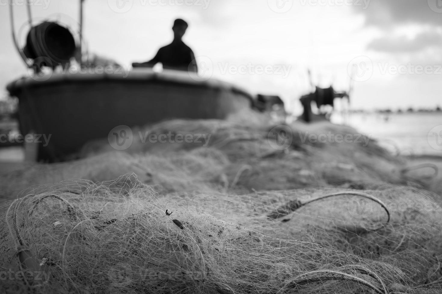 Sea nets - fishing equipment or tackle as texture backdrop with natural sunlight and shadow. Black and white textured background of fishing nets close-up, marine design for craft of fishermen. photo