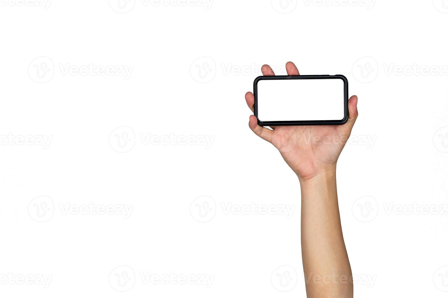 Asian Thai male isolated hand hold Smart mobile phone and raise up in horizontal direction with empty copy space on white background. photo