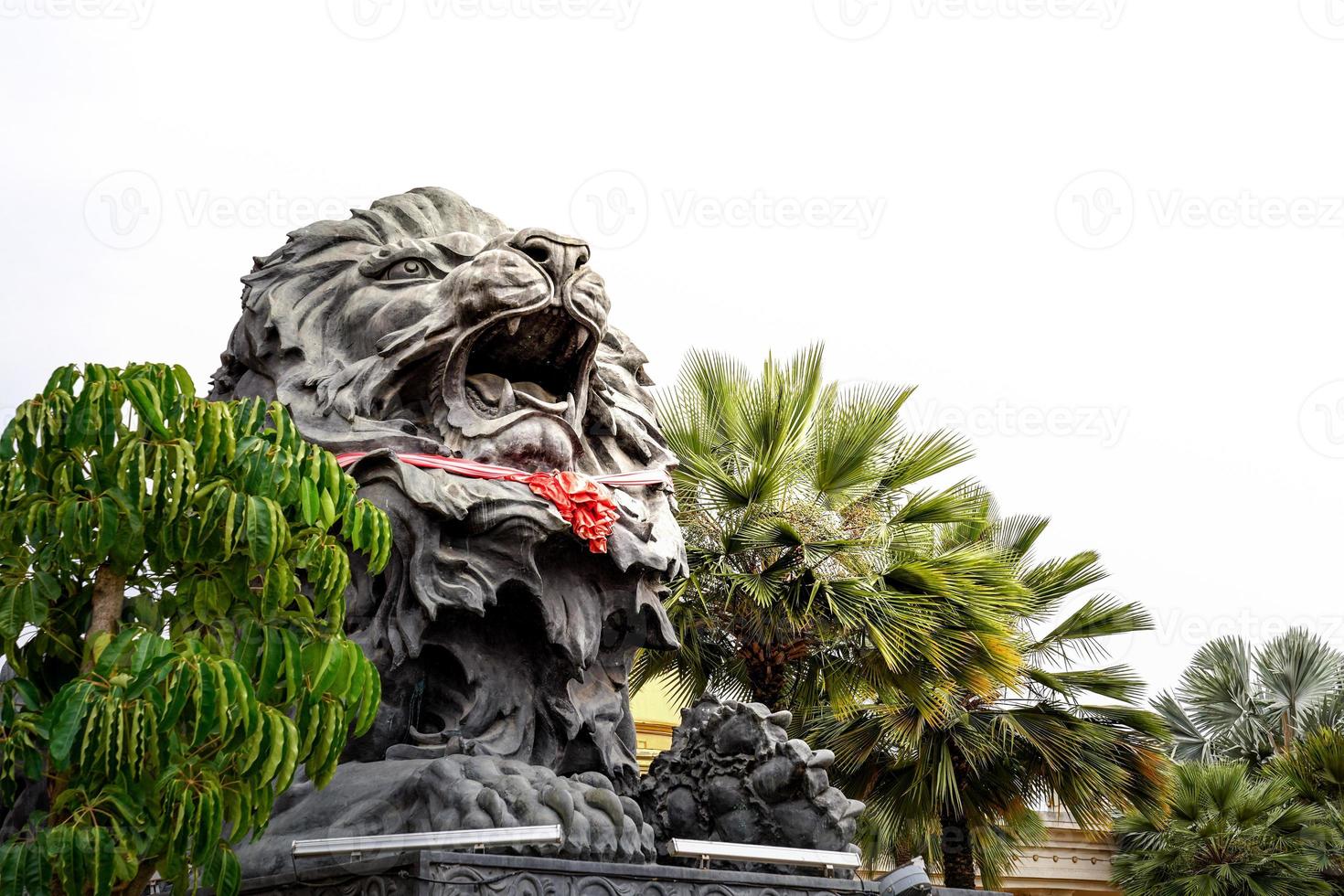 big black lion statue front of building. photo