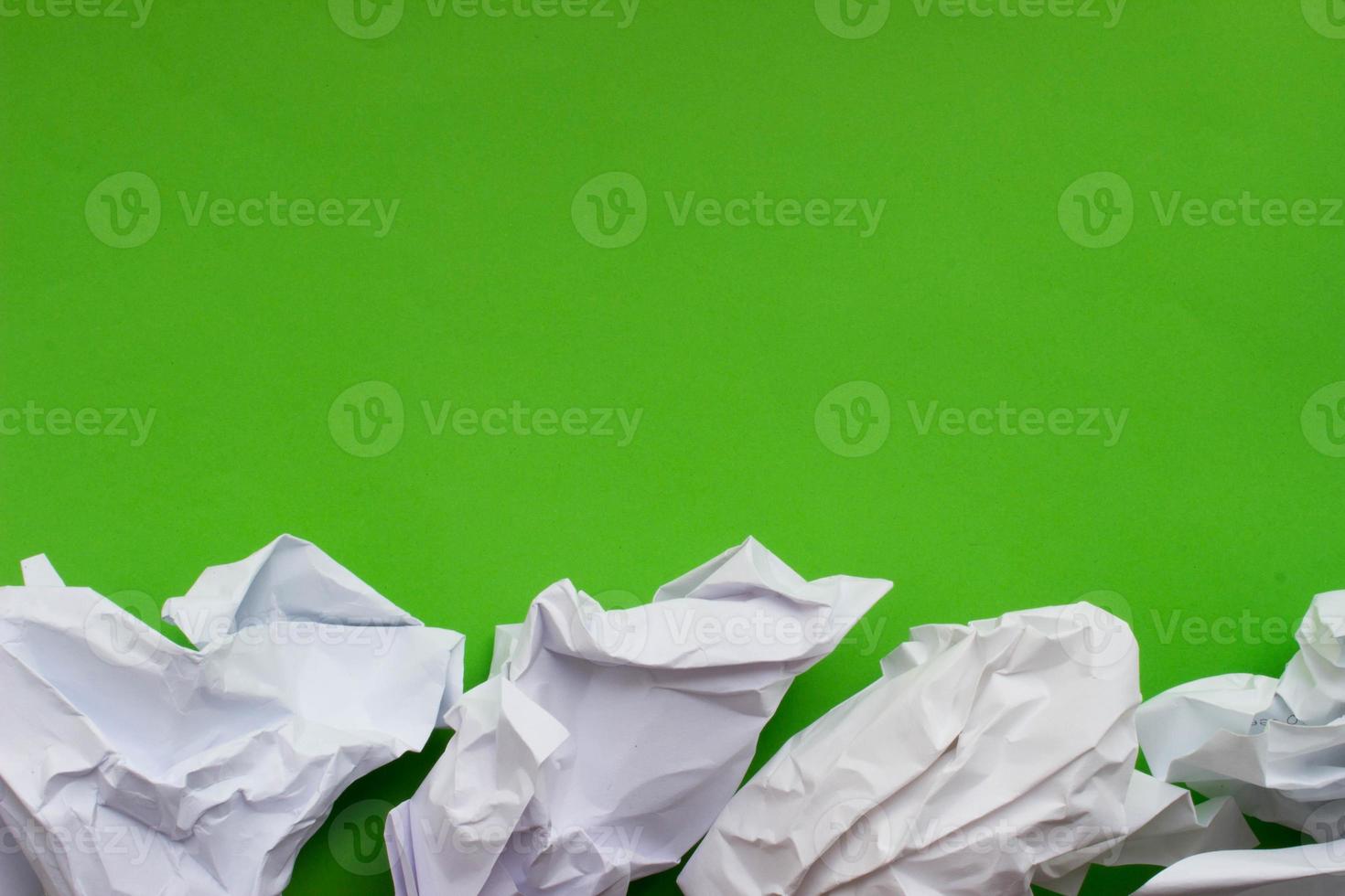 Crumpled paper on green background with place for your design photo