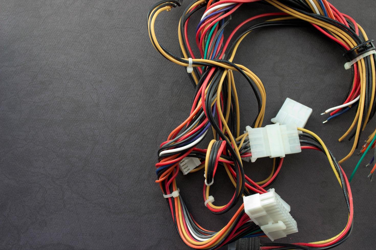 Multi-colored wires from a desktop computer. Wires leading electricity to individual PC components. Background with place for your design photo