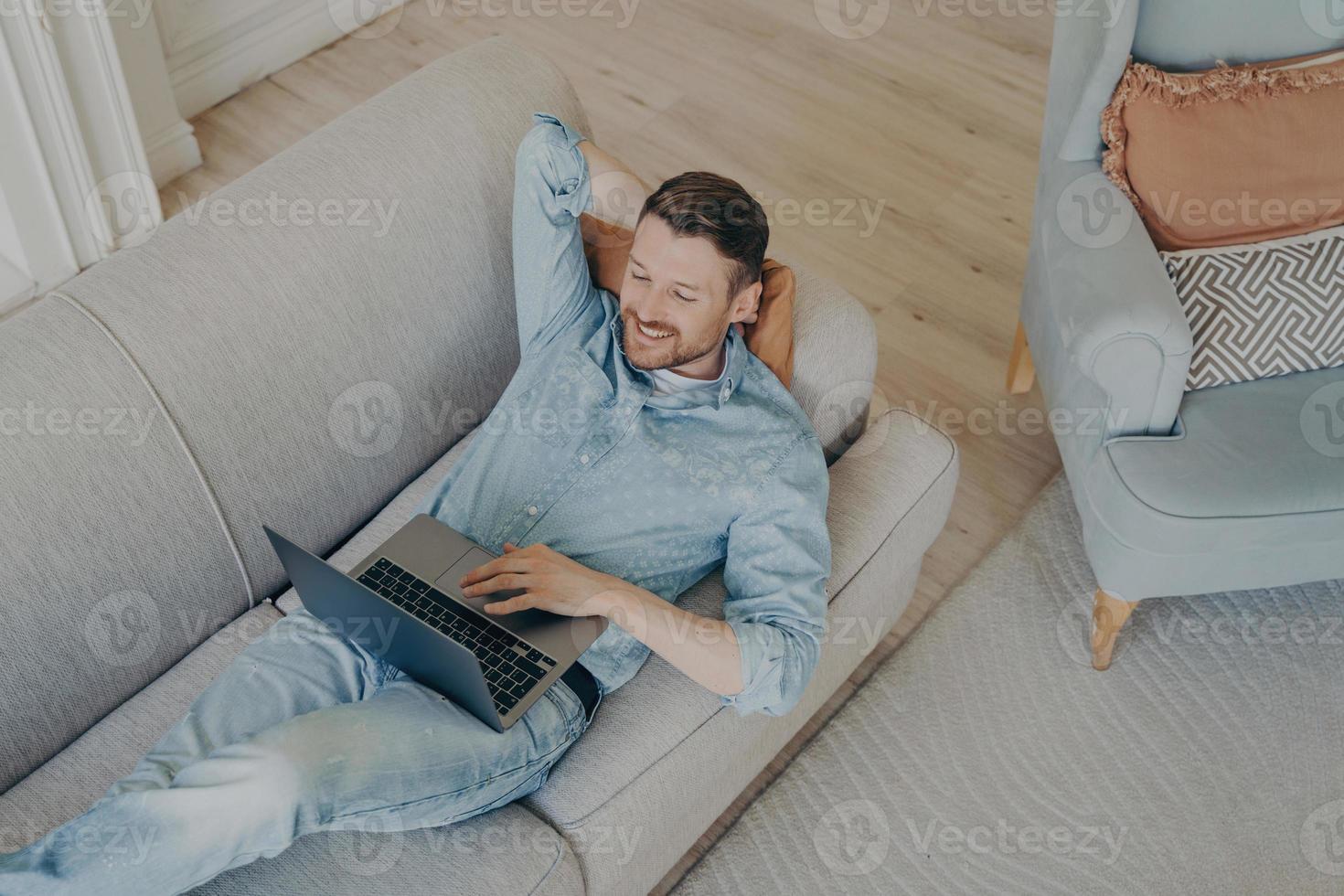 Young business company worker in casual clothes relaxing after successful online presentation photo
