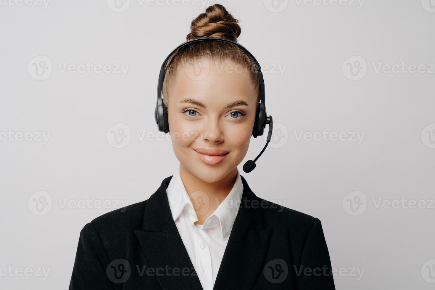 Female customer service representative in dark suit listening to customer photo