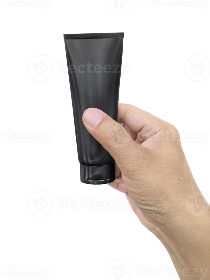 Human hand holding Cosmetic plastic tube isolated on white background photo