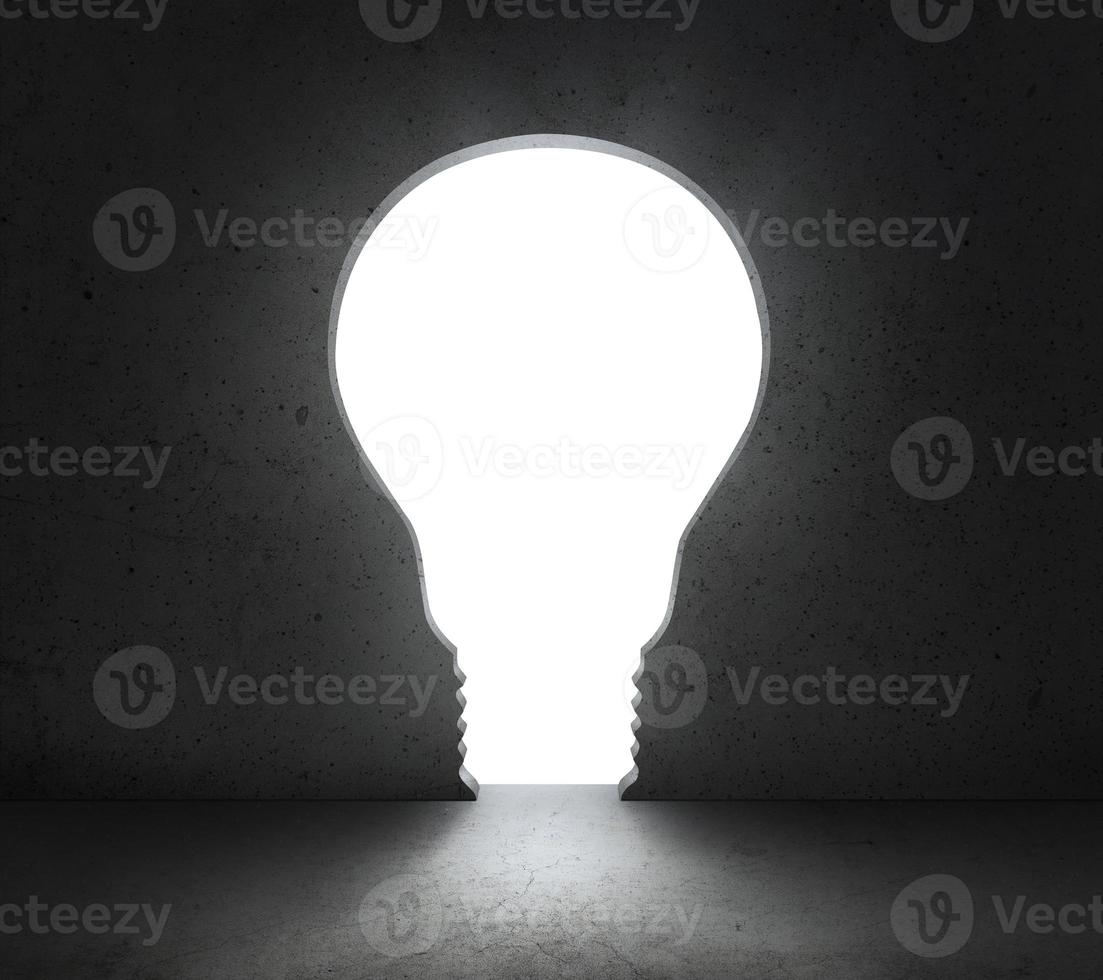 front of bright big light bulb shining door in a concrete wall photo