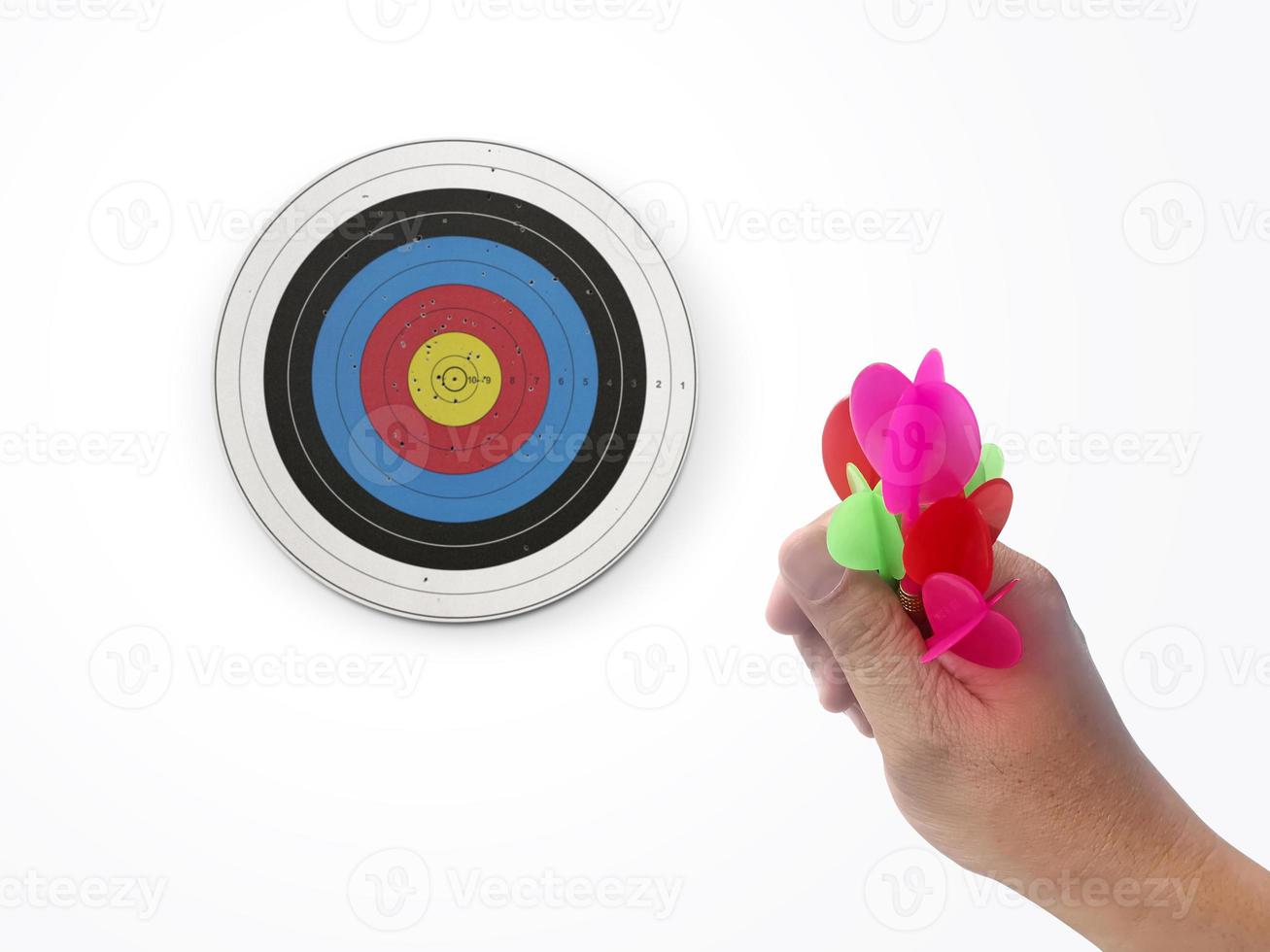 Human hand is throwing the darts target to the darts board. a man's hand throws a dart at the target photo