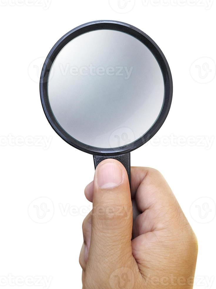 Hand holding a magnifying glass isolated on a white background photo