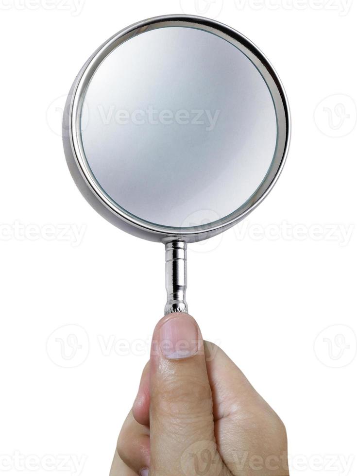 Hand holding a magnifying glass isolated on a white background photo