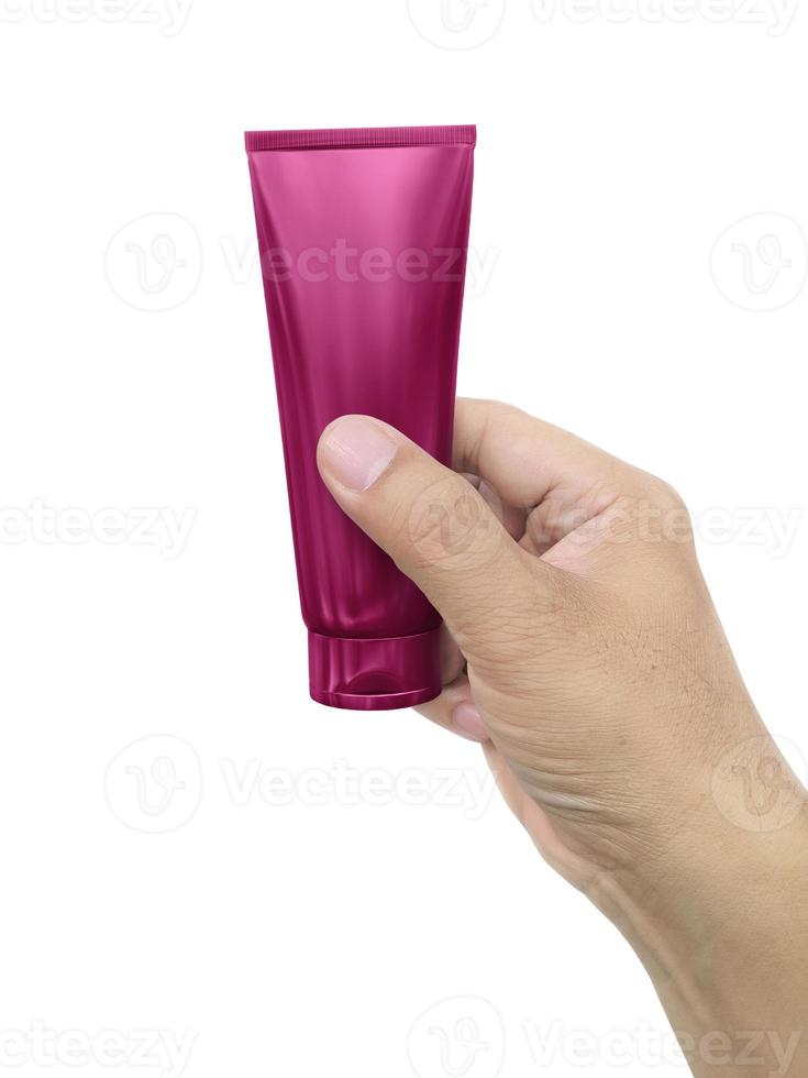 Hand holding Cosmetic plastic tube isolated on white background photo