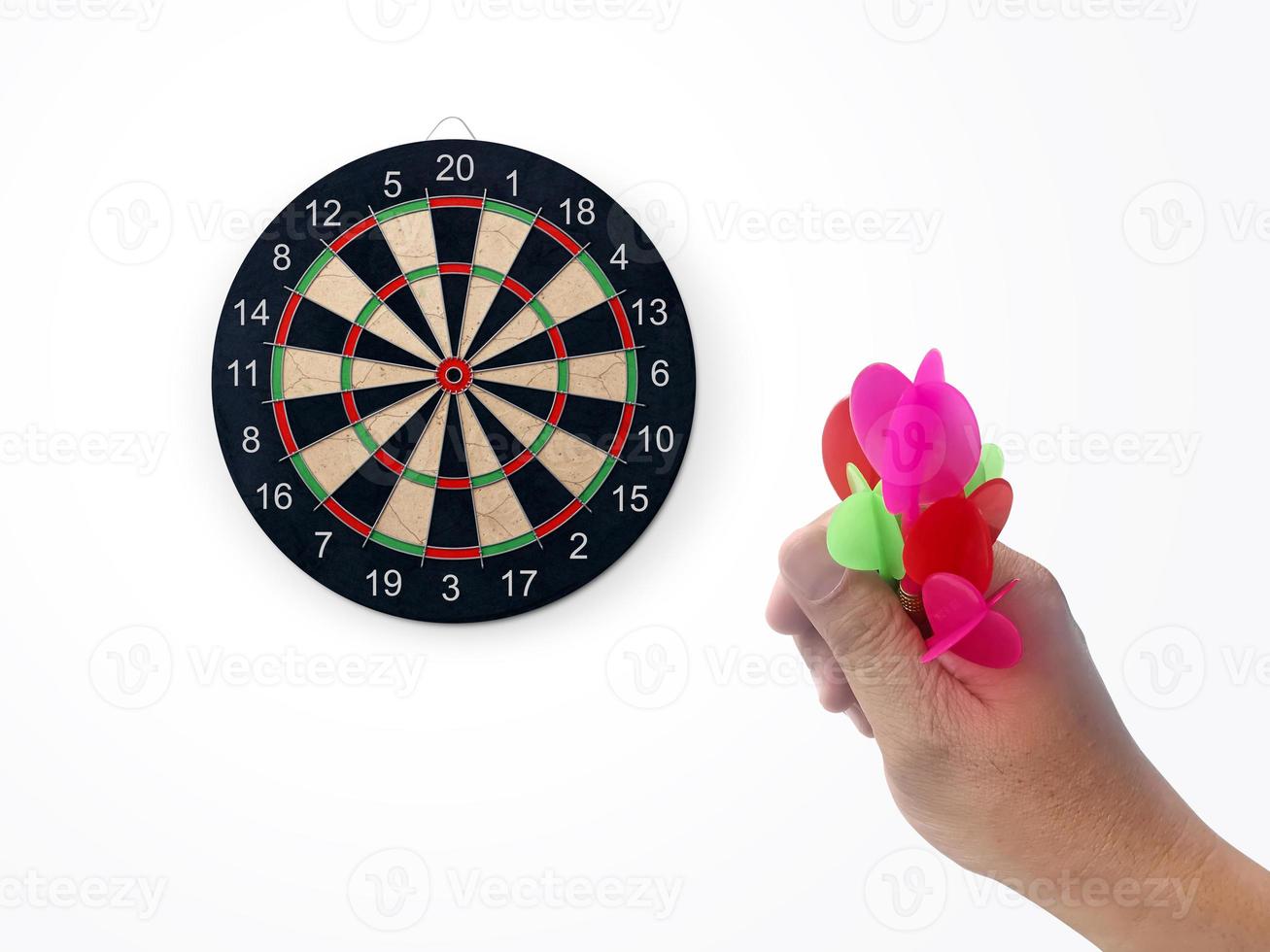 Human hand is throwing the darts target to the darts board. a man's hand throws a dart at the target photo