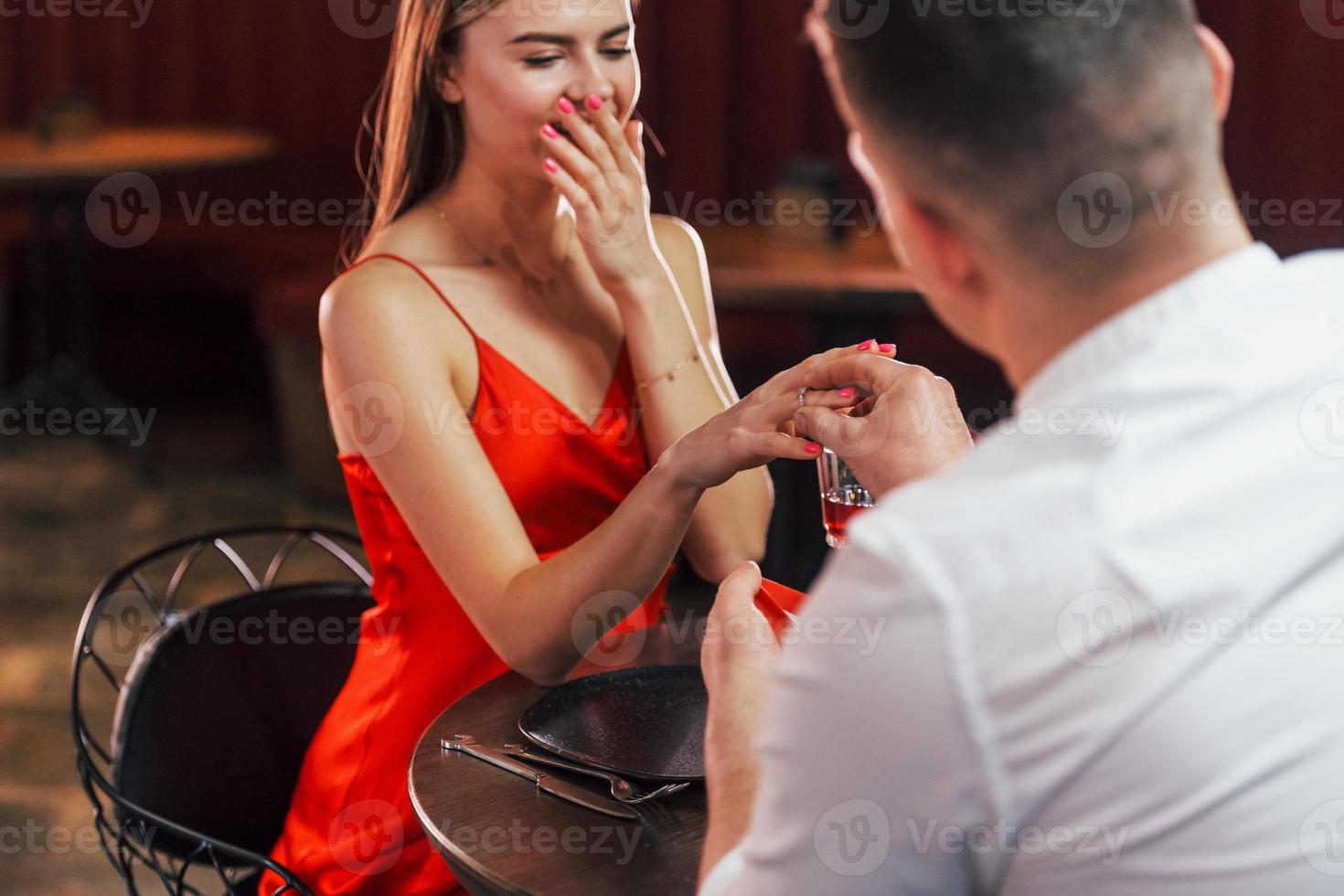 Making marriage proposal. Romantic couple have dinner in the restaurant photo